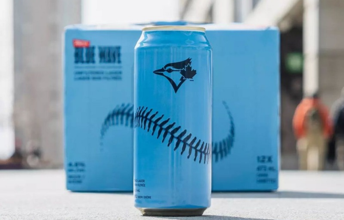 A blue and white beer can with a baseball seam design and a bird logo.