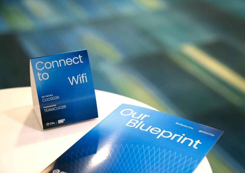 A blue Wi-Fi sign and pamphlet titled "Our Blueprint" are displayed on a table.