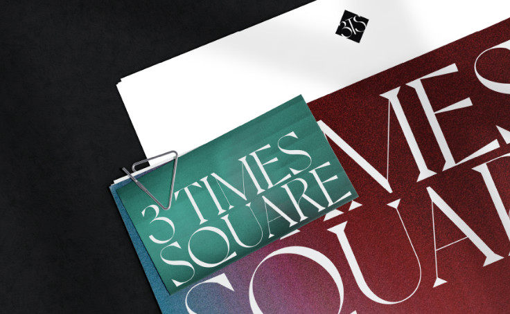 A small card with "3 Times Square" clipped to a larger red and white document.